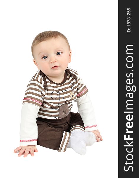 Cute baby boy sitting against a white background. Cute baby boy sitting against a white background