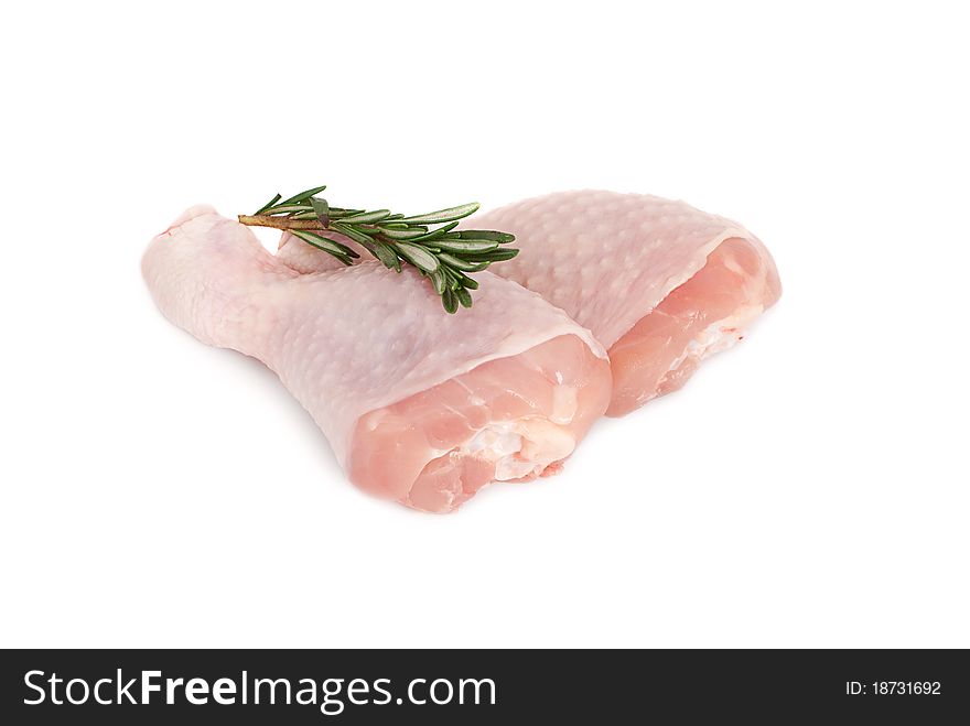 Two raw chicken drumsticks on a white background