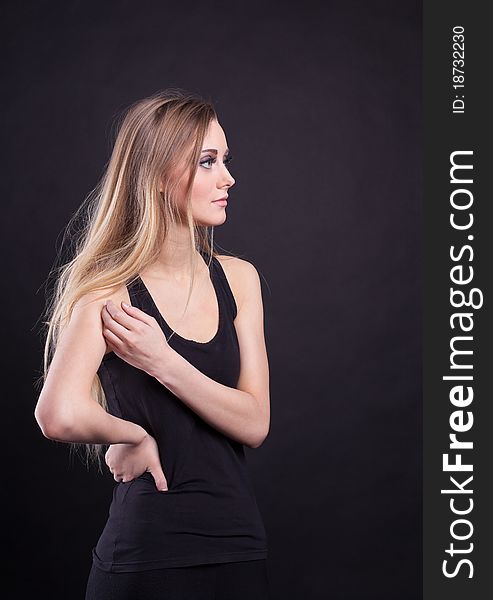 Young tall blond girl pose in black tank top