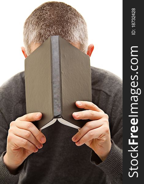 Isolated man behind a book