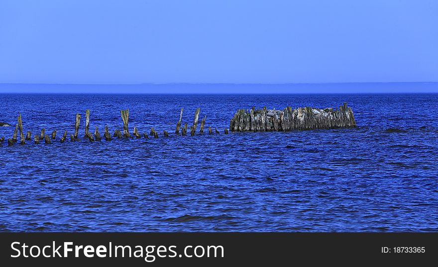 Old wooden pier in the sea, summer in Latvia. Old wooden pier in the sea, summer in Latvia.