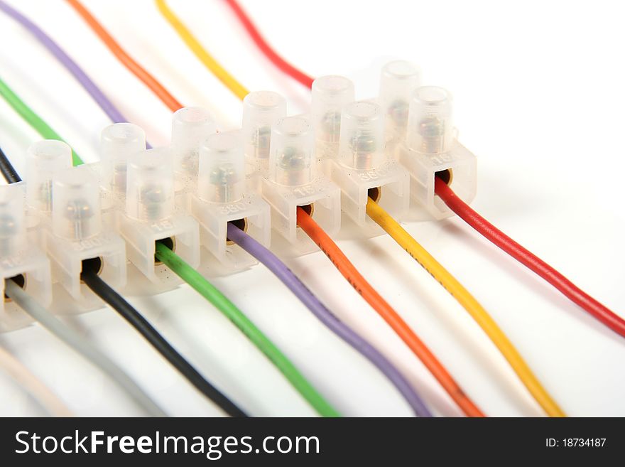 Closeup of colorful electric wires in connectors isolated on white background