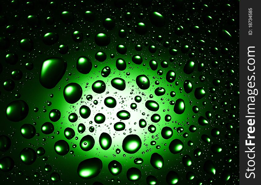 Round water drops on green background close-up. Round water drops on green background close-up