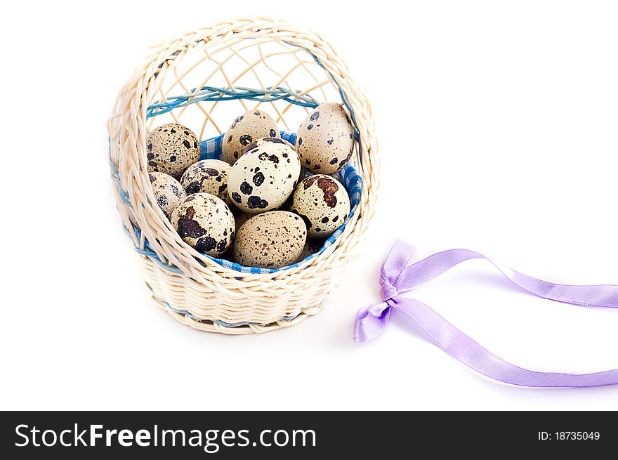 Quail eggs in basket isolated on white