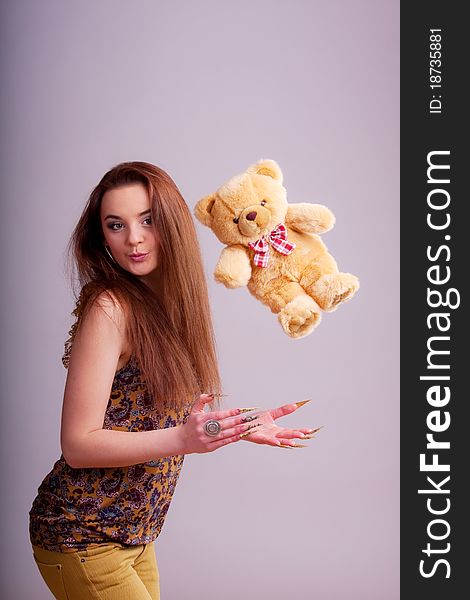 Beautiful young longhair brunette playing with bear. Beautiful young longhair brunette playing with bear