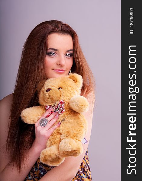 Beautiful longhair girl is holding the teddy bear. Beautiful longhair girl is holding the teddy bear