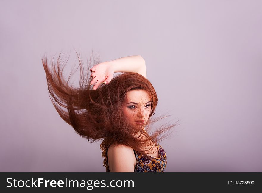 Portrait of a pretty  girl with hair fluttering in the wind. Portrait of a pretty  girl with hair fluttering in the wind