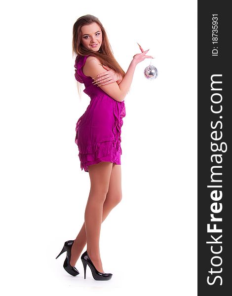 Beautiful long-haired brunette in a dress of fuchsia and a disco ball. Beautiful long-haired brunette in a dress of fuchsia and a disco ball