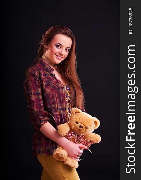 Beautiful longhair girl is holding the teddy bear. Beautiful longhair girl is holding the teddy bear