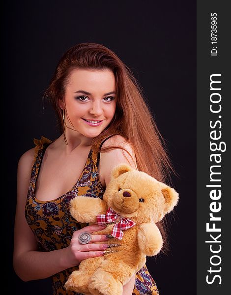 Beautiful longhair girl is holding the teddy bear. Beautiful longhair girl is holding the teddy bear