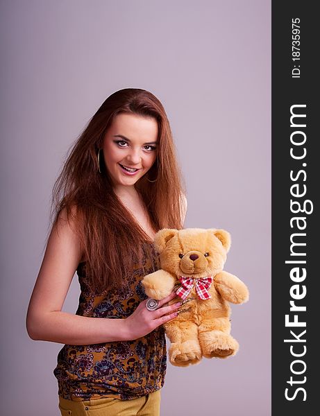 Beautiful longhair girl is holding the teddy bear. Beautiful longhair girl is holding the teddy bear