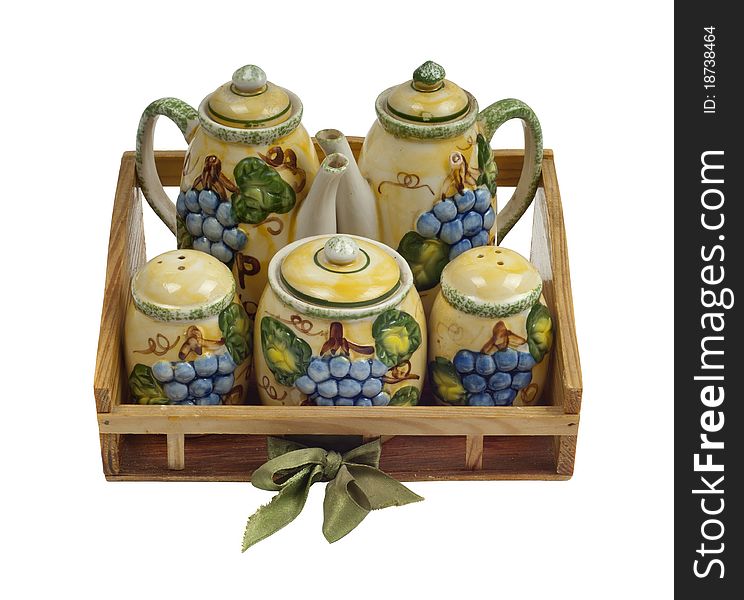 Isolated photo of a decorative table set. The set includes spice, pepper, salt, sugar, tea and milk cases. Isolated photo of a decorative table set. The set includes spice, pepper, salt, sugar, tea and milk cases.