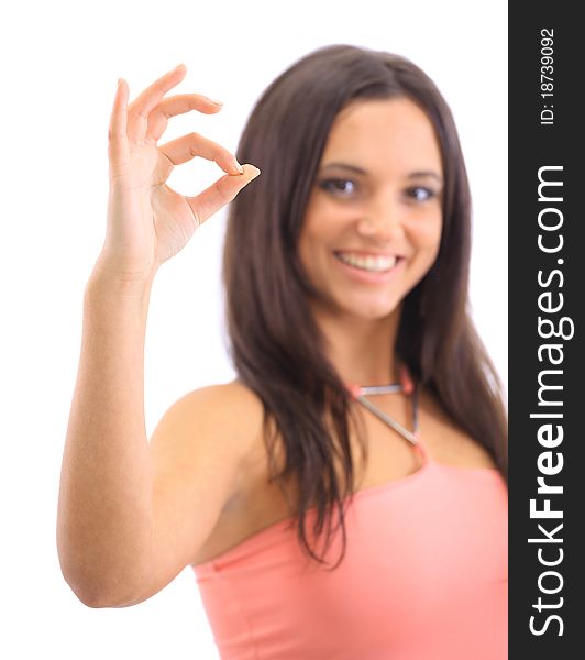 Portrait of a cute female showing an OK sign isolated over white background