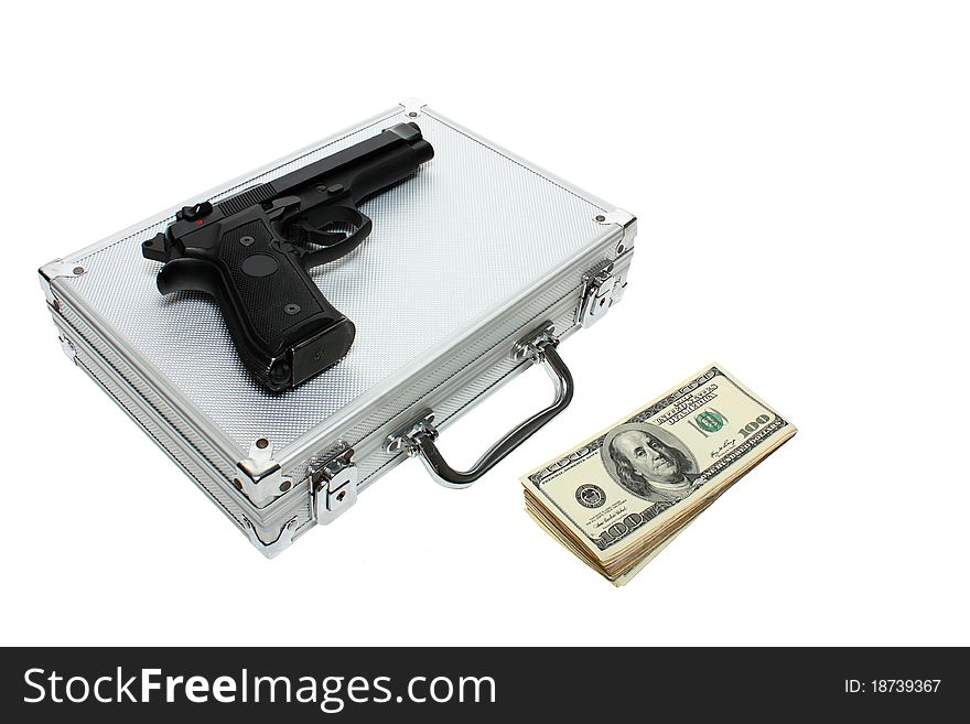 A metal briefcase,stack of money and a black gun isolated on a white background. A metal briefcase,stack of money and a black gun isolated on a white background