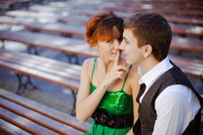 Young Couple Sitting Together On Park Bench Stock Image