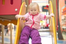 Adorable Baby Sliding Down On Playground Stock Photos