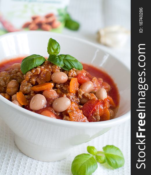 A bowl of chilli with bean and minced meat. Soft focus, shallow depth of field. A bowl of chilli with bean and minced meat. Soft focus, shallow depth of field.