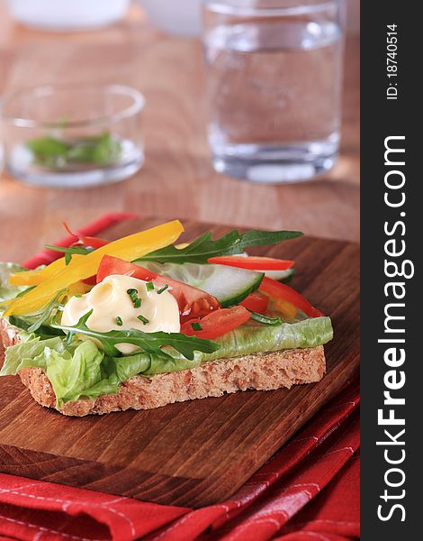 Slice of brown bread with fresh vegetables. Slice of brown bread with fresh vegetables