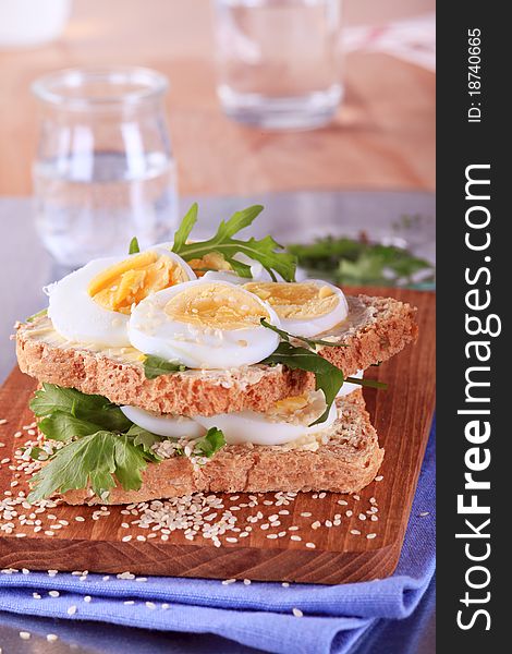 Whole wheat egg sandwich on a cutting board