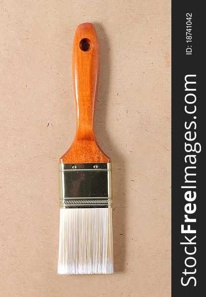 New wooden paint brush on wooden table