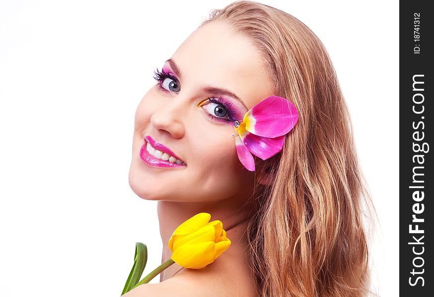 Beautiful young woman with a flower and creative makeup with tulip petals. Beautiful young woman with a flower and creative makeup with tulip petals