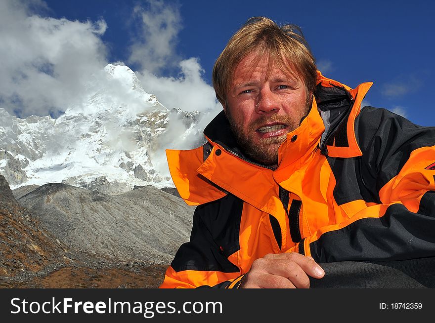 Climber tired but confident after climbing the Ama Dablam mountain (in the background) in the Himalayas, Nepal. Climber tired but confident after climbing the Ama Dablam mountain (in the background) in the Himalayas, Nepal