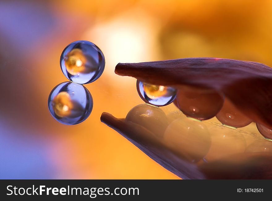 Several mirrored marbles on yellow background