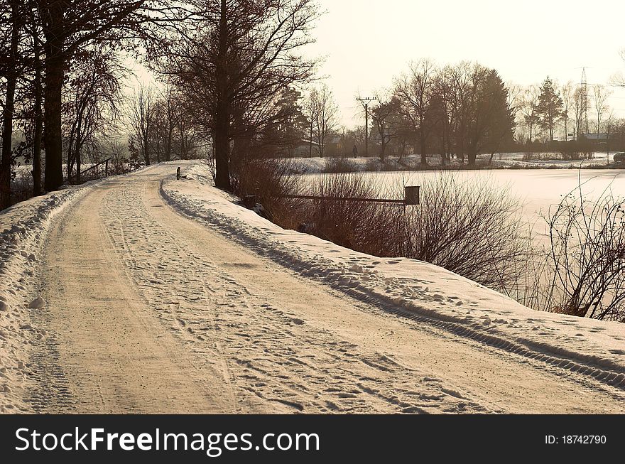 Winter road near a pond