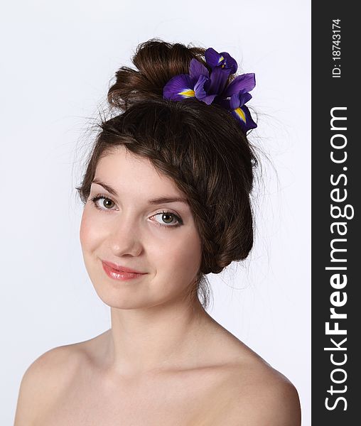 Portrait of the beauty young brunette girl with iris in her hair