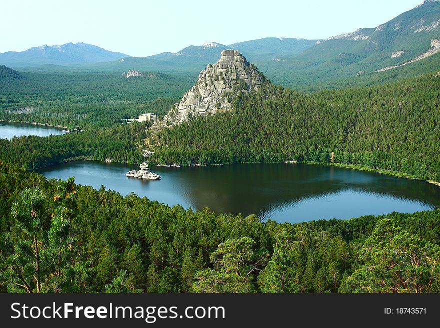 Landscape, shot from above, depicting the mountains, covered with coniferous forests. Landscape, shot from above, depicting the mountains, covered with coniferous forests.