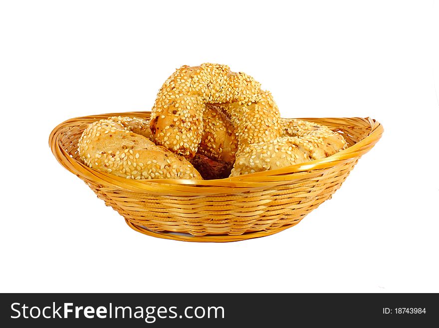 Small rolls in a little woven basket isolated on white