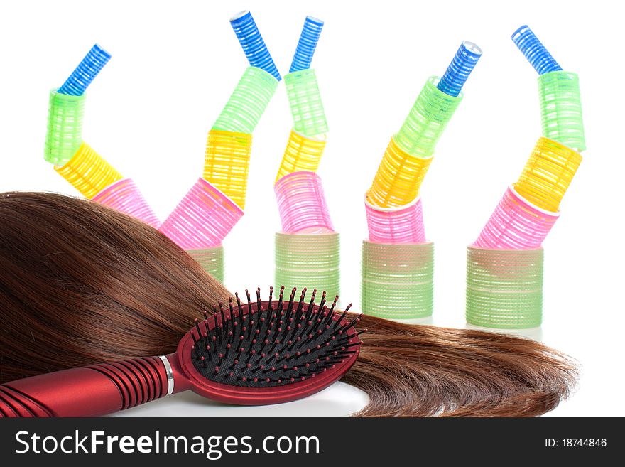 Brown hair, comb and hair curlers | Isolated