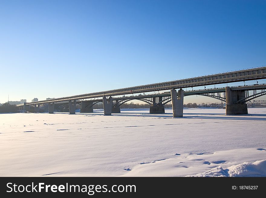 Two bridges across river winter against blue sky, Russia. Two bridges across river winter against blue sky, Russia