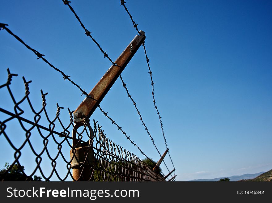 Barbed wire fence protect land from trespassers. Barbed wire fence protect land from trespassers.