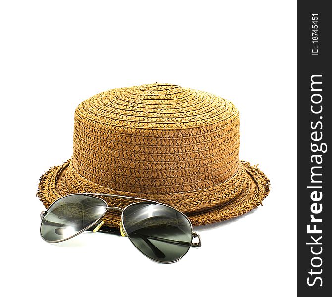 Straw hat and sunglasses isolated on a white background