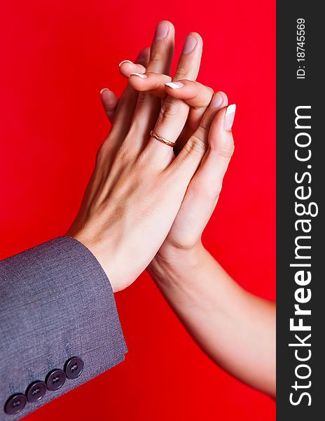 Hands of a bride and a groom with golden wedding rings