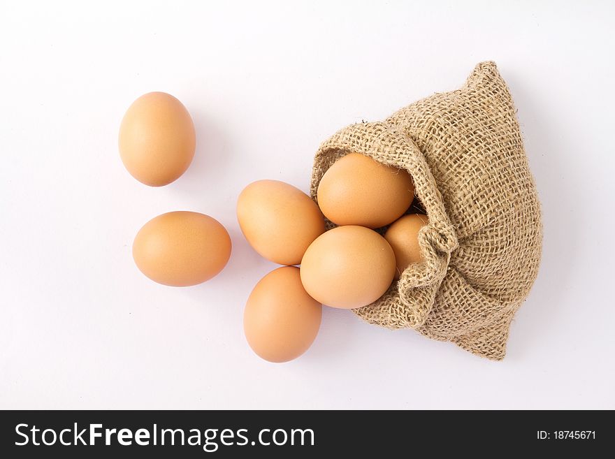 Brown eggs in canvas sack isolated on a white background