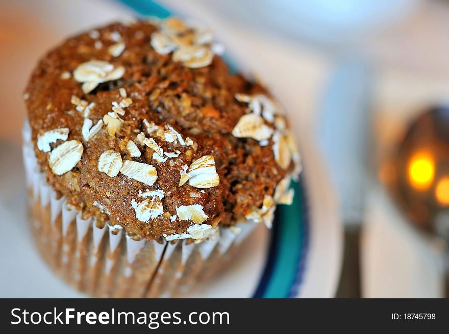 Singe brown muffin on white plate. Singe brown muffin on white plate.