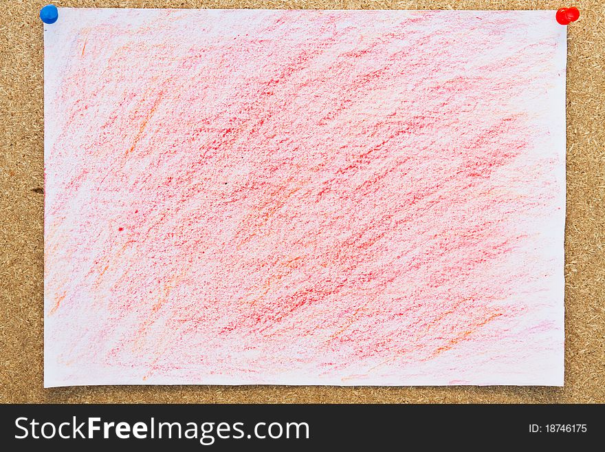 The red crayon painted on the white paper and peg on board. The red crayon painted on the white paper and peg on board