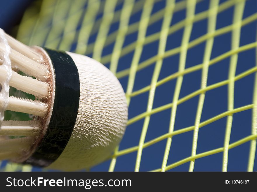 Close-up badminton action. Part of shuttlecock an racket strings. Close-up badminton action. Part of shuttlecock an racket strings.