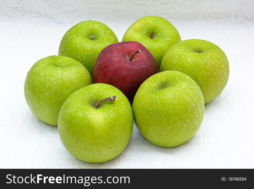 A green apple is besieged by green apples. A green apple is besieged by green apples.