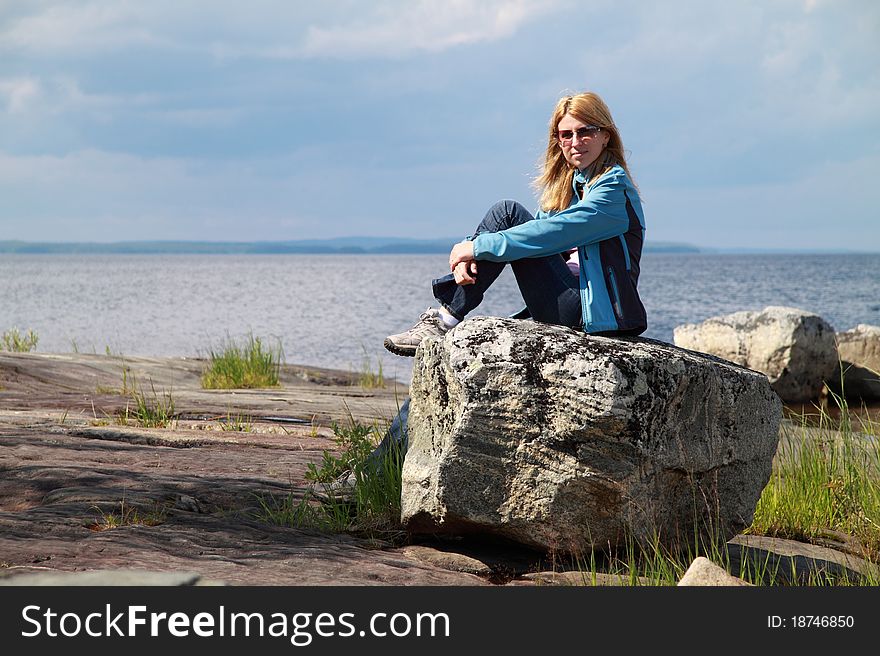 Female tourist is enjoying the peaceful lakeside in Eastern Finland. Female tourist is enjoying the peaceful lakeside in Eastern Finland.