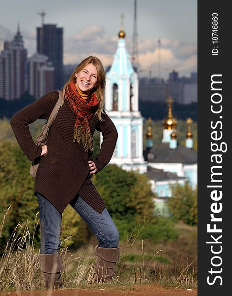 Proud russian woman standing with a russian church behind her. Proud russian woman standing with a russian church behind her.