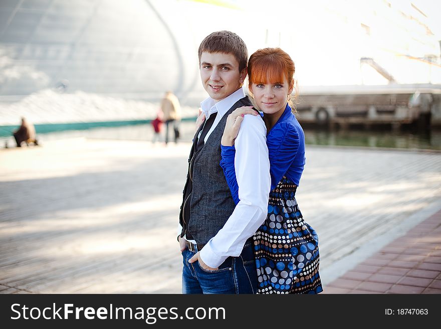 Portrait of a cute young couple together with arms around