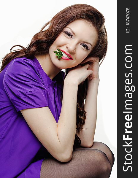 Portrait of beautiful smiling girl with peppermint against white background