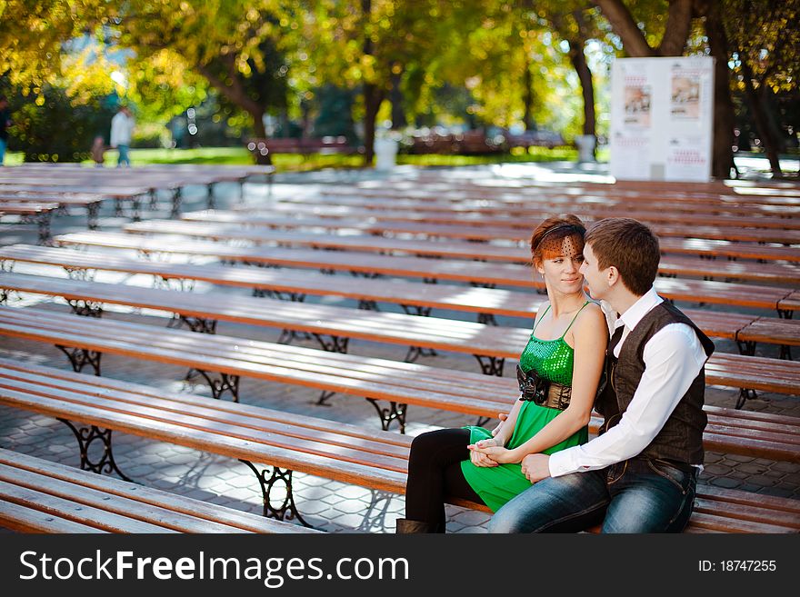 Shot of young Couple Sitting Together On Park Bench