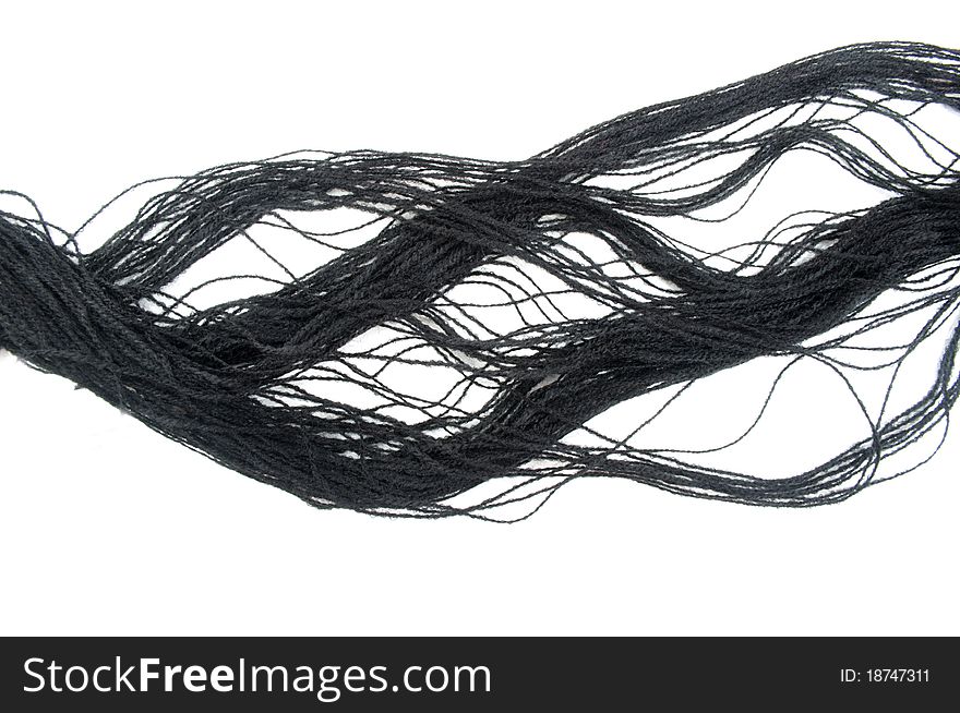 Black cotton thread on a white background
