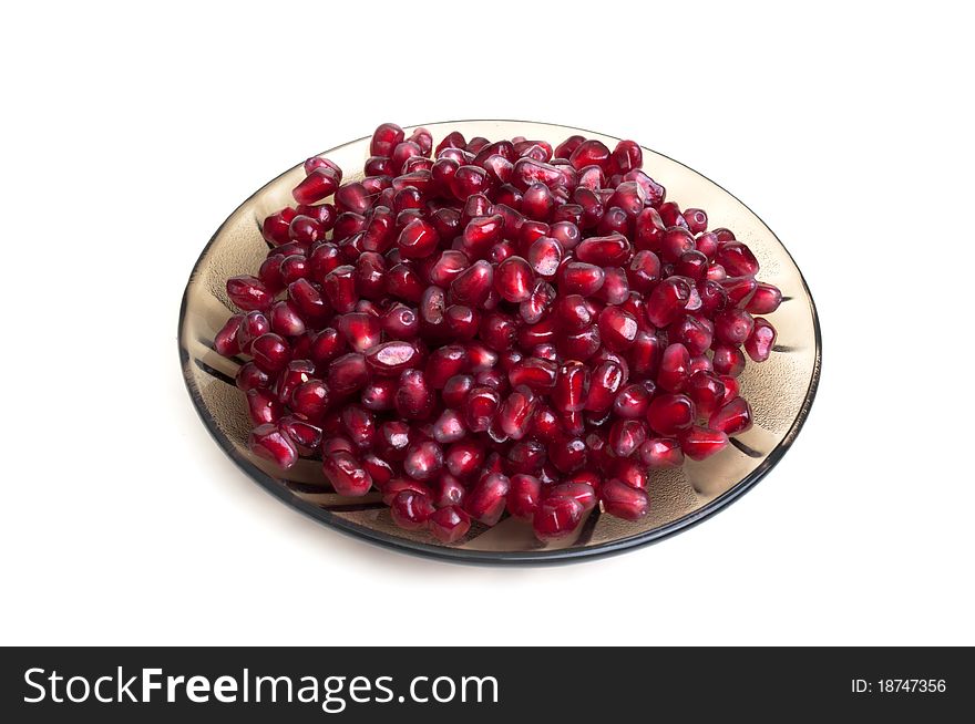 Many seeds with pomegranate on a white background