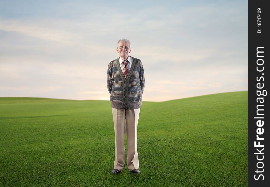 Smiling senior man on a green meadow. Smiling senior man on a green meadow