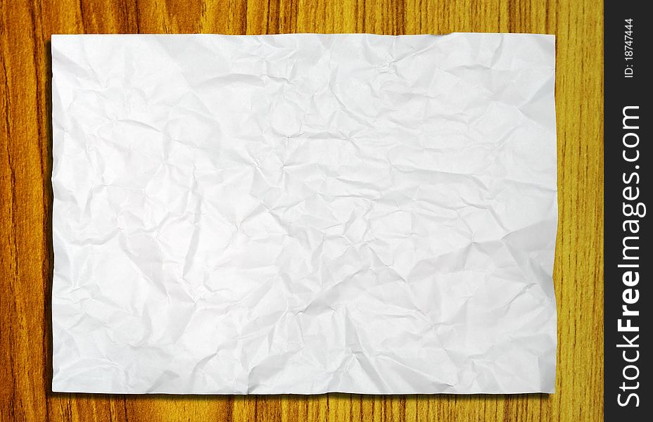 White crumpled paper on wood